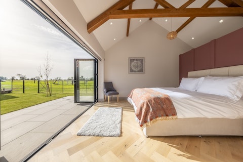 Wake to Suffolk scenery flooding in through full-width glazed doors