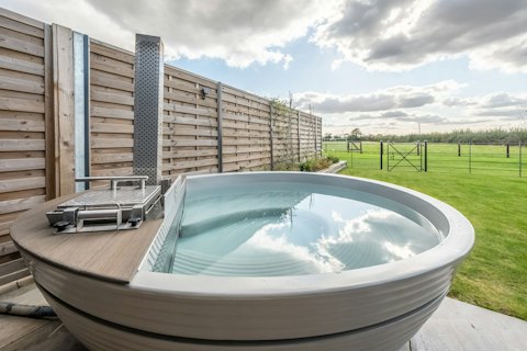 Admire the country views while soaking in the wood-fired hot tub
