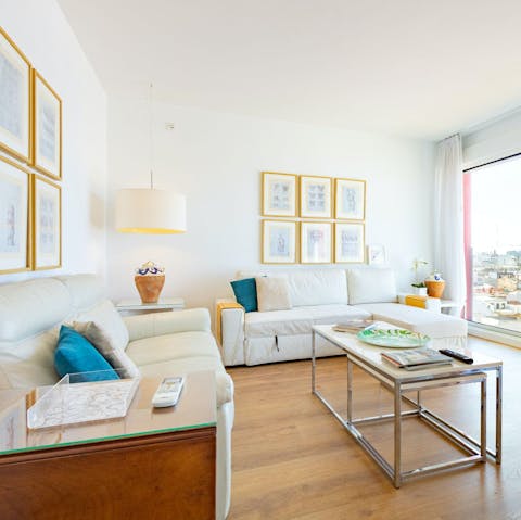 Watch the sun set over the city from the living area's floor-to-ceiling windows