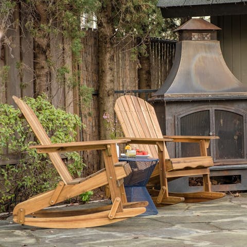 Kick back on the outdoor rocking chairs by the fire, while chatting with a loved one
