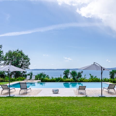 Lie back on a lounger and watch the sun set into Lake Garda