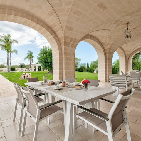 Dine alfresco with views of the lush garden on the shaded patio
