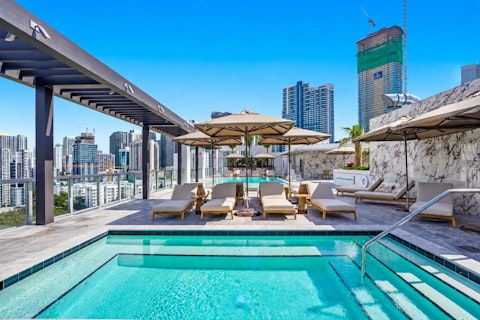 Cool off in the shared pool with the Miami skyline overhead