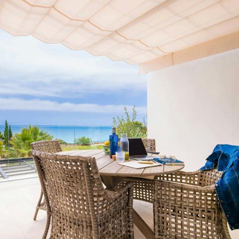 Grab a seat on the shaded terrace and catch up on some work at the outdoor table