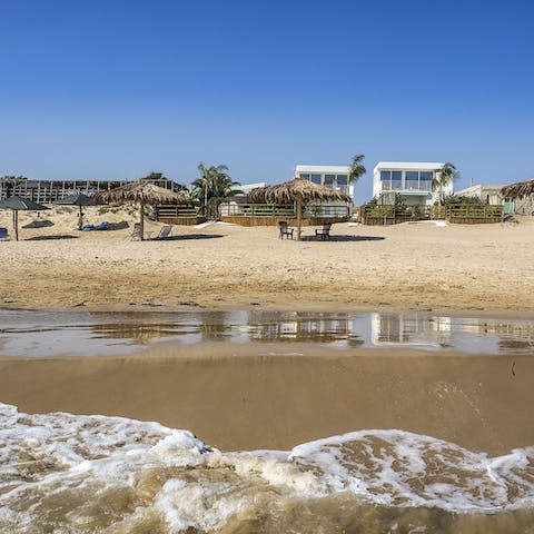 Walk just a few seconds out of the home and onto the beach