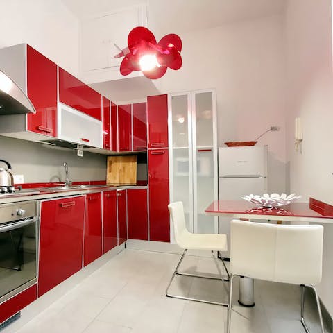 Start mornings with fresh coffee and locally bought pastries in the sleek, red kitchen