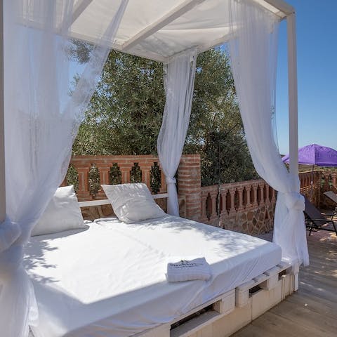 Relax on the daybed outdoors and watch the world go by