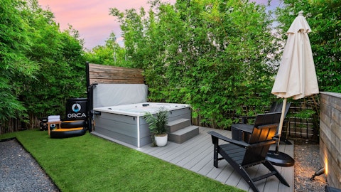 Ease into the hot tub beneath a blush-pink sky