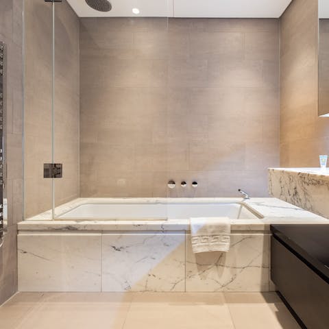 Relax in the marble bathroom after a busy day in London
