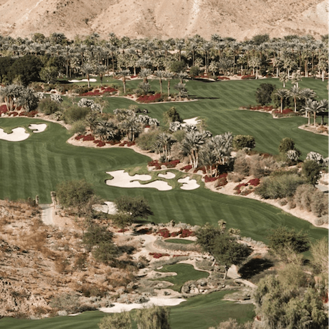 Play a round of golf beside the mountains