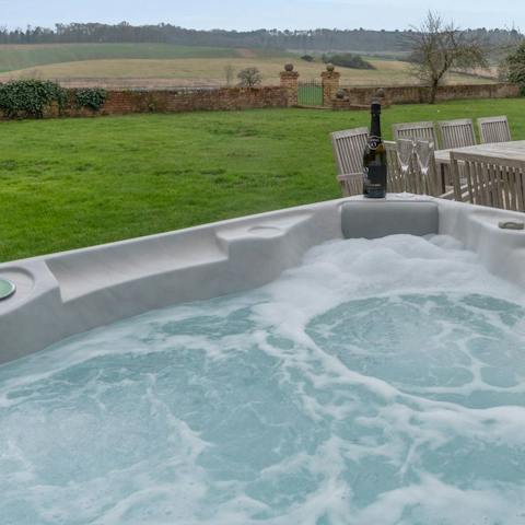 Relax and unwind in the huge outdoor hot tub, with stunning country views around you