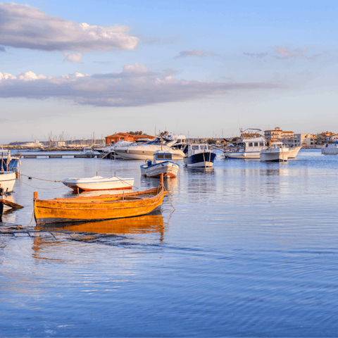 Take walks along the charming harbour of Marzamemi, a six-minute-drive away