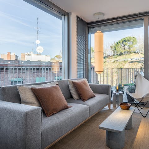 Kick back in amidst the plush interiors of the living area after a day of sightseeing in Madrid