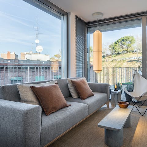 Kick back in amidst the plush interiors of the living area after a day of sightseeing in Madrid