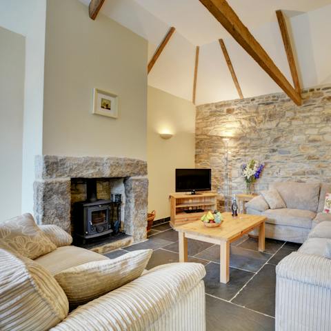 Listen to the crackle of the wood-burning stove as you sink into the soft sofa