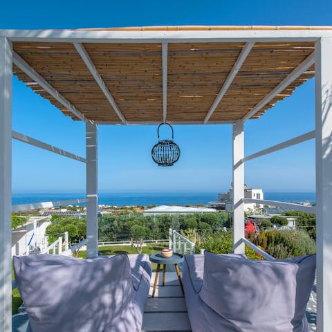 Sit back under the pergola to admire the beautiful views on the horizon