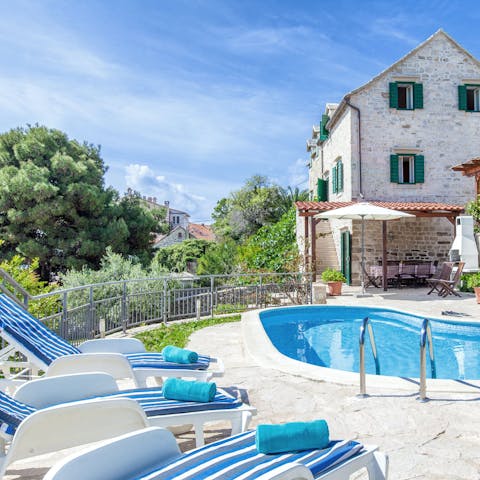 Grab your pool towel and head out to the poolside sun loungers for a relax