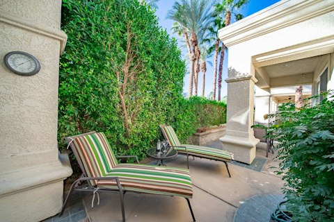 Laze away the afternoon on the sun-loungers under swaying palms and open sky