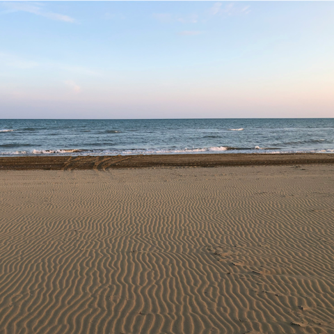 Sunbathe on the sand at Spiaggia Pantanello, 20km away