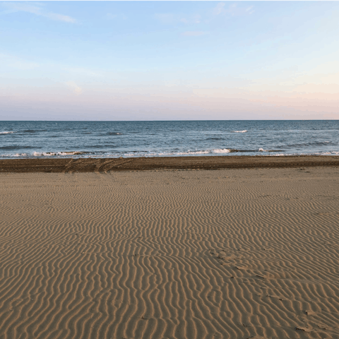 Sunbathe on the sand at Spiaggia Pantanello, 20km away