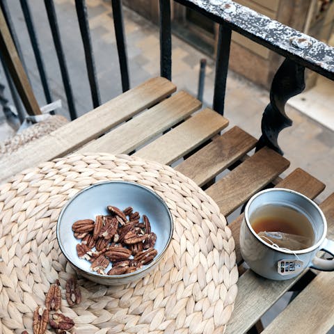 Bring a snack and a cup of tea out to the balcony