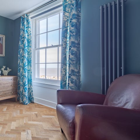 Curl up on the master bedroom's armchair with a good book while admiring sea views