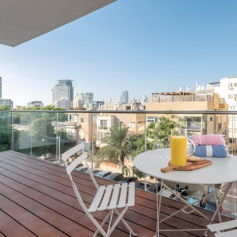 Admire the sweeping city vistas from the private balcony