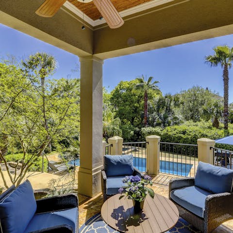 Find a shady spot on the secluded terrace surrounded by greenery
