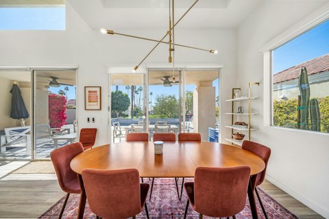 Gather around the table for dinner and drinks as palm trees frame the view