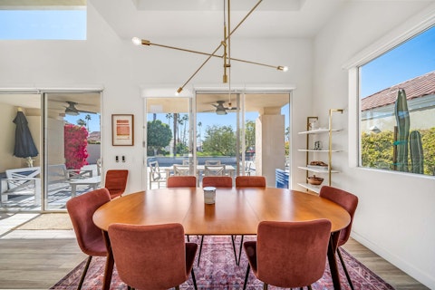 Gather around the table for dinner and drinks as palm trees frame the view