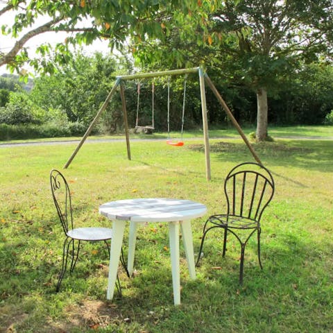 Relax with a coffee while the kids play on the swings