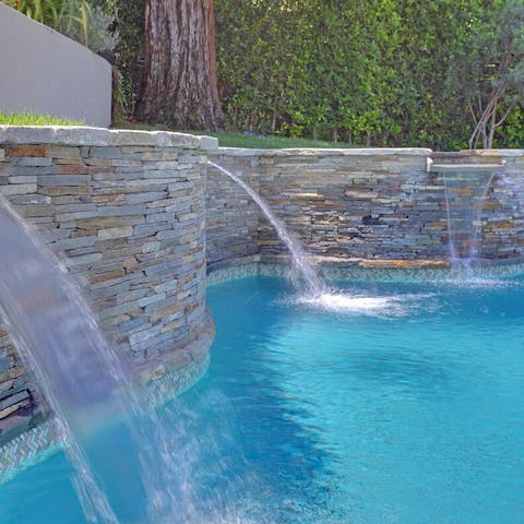Loll under the swimming pool waterfalls for some hydrotherapy
