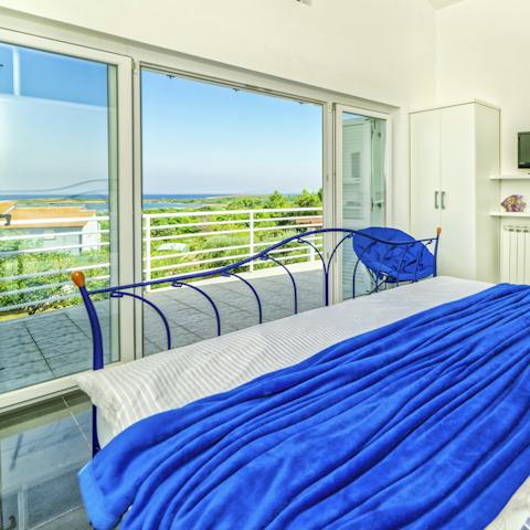 Appreciate the sunshine bathing the bedroom and step out onto the private balcony
