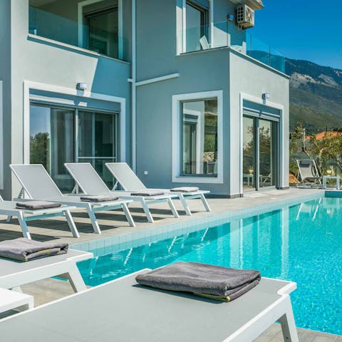 Laze on sun loungers before a swim in your private infinity pool