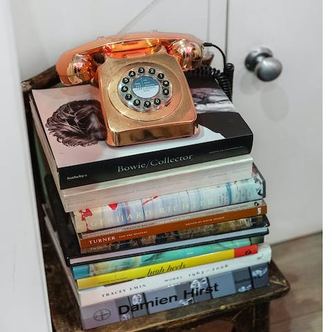 Admire the home's curated art and book collection
