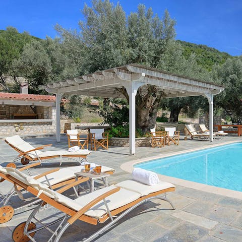 Read or recline on luxe loungers beside the pool