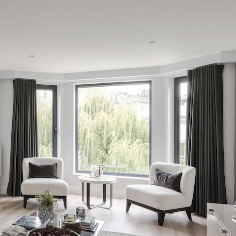 Sip a gin and tonic by the natural light of the gorgeous bay windows