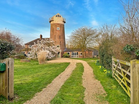 Arrive at a centuries-old windmill set in open Norfolk countryside