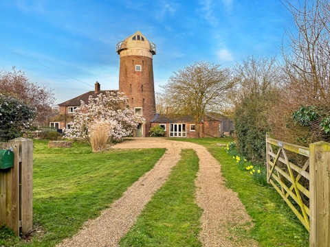Arrive at a centuries-old windmill set in open Norfolk countryside