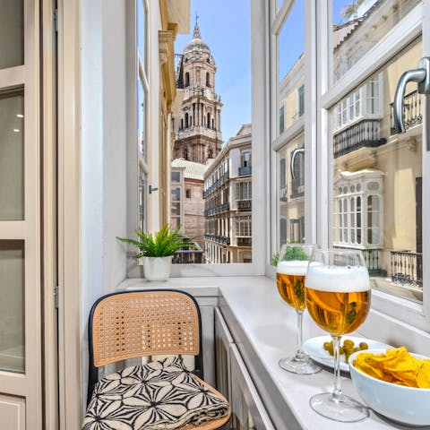 Look out to views of Malaga Cathedral from the apartment's glazed balcony