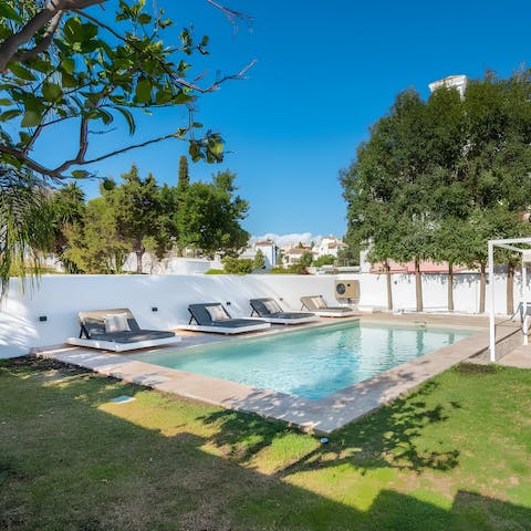 Lounge in the sun by the private heated pool