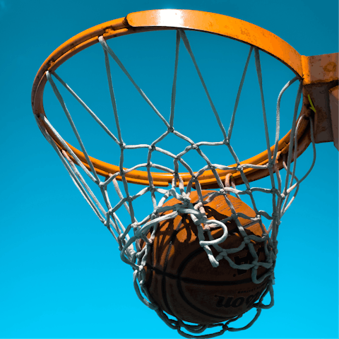 Play a competitive game of basketball on the outdoor court