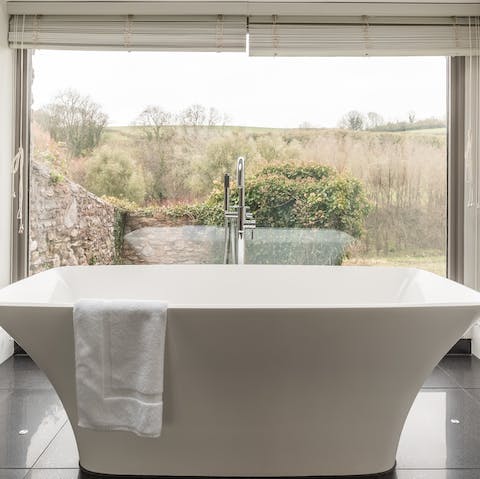 Lie back in the bathtub and watch the world go by through the large window