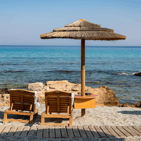 Sit by the gentle rays of the sea at Lachanias Beach, just an eleven-minute-walk away