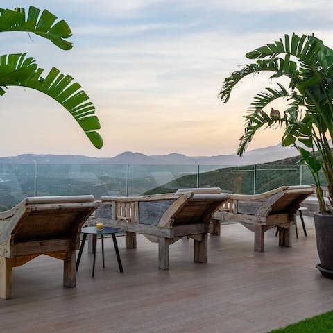 Catch the sunset from the day beds overlooking the majestic Mijas mountains