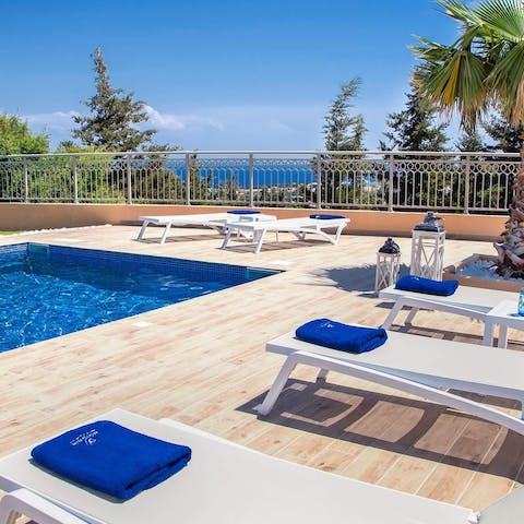 Work on your tan under the Aegean sun after a dip in the pool