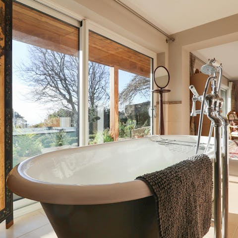 Sink into the freestanding bath with views of the sea