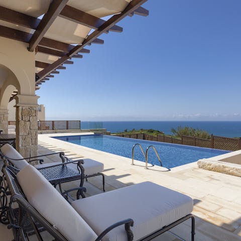 Laze on luxe loungers in the sun before cooling off with a refreshing dip in the outdoor infinity pool