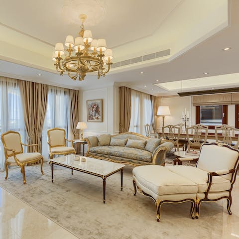 Admire this home's opulent aesthetic – all chandeliers and gilt-edged furniture