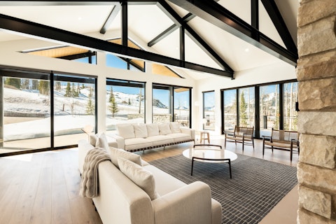Gather under steel beams with snow-covered slopes as a backdrop